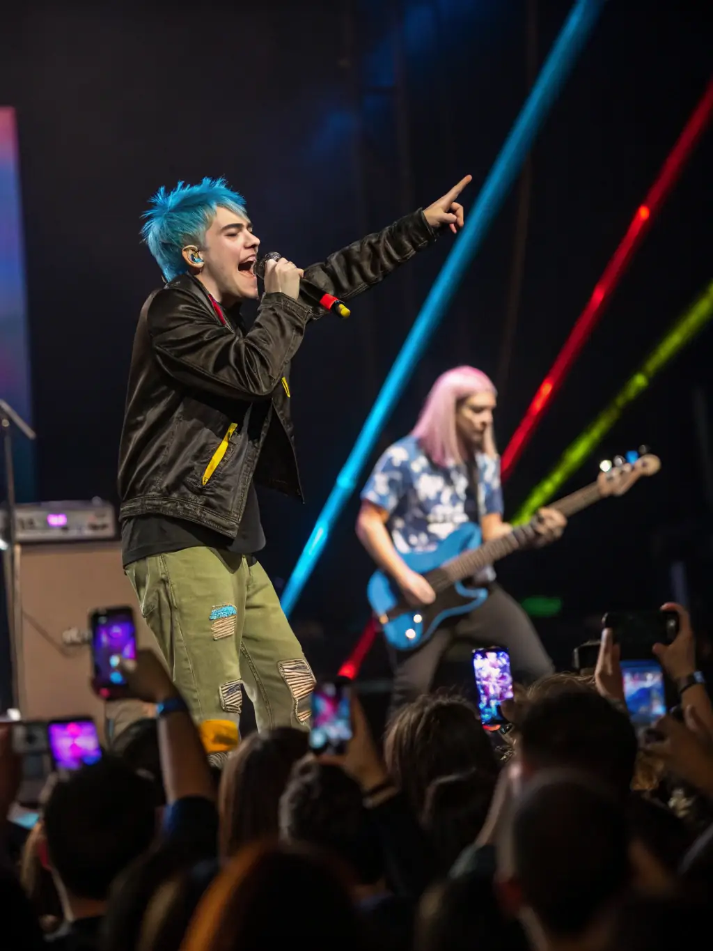 A vibrant image of a live metal concert, showcasing the energy and excitement of the event, with a focus on the band performing on stage and the enthusiastic crowd.